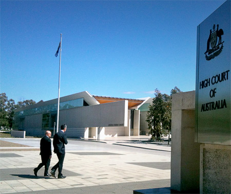 Michael Malone and Steve Dalby walk towards the High Court of Australia